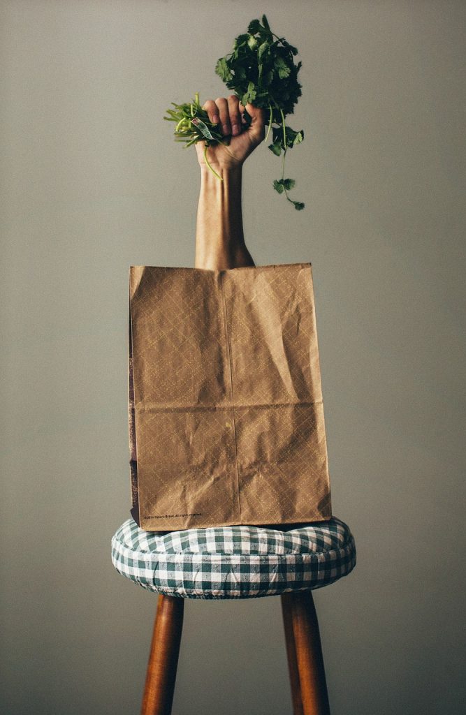 Eco-friendly products including reusable bags, bamboo cutlery, and organic skincare displayed on a table