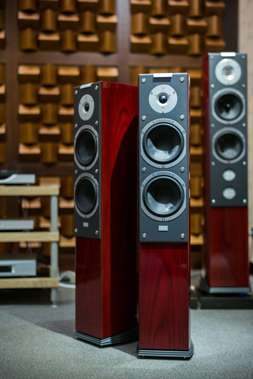 three red tower speakers