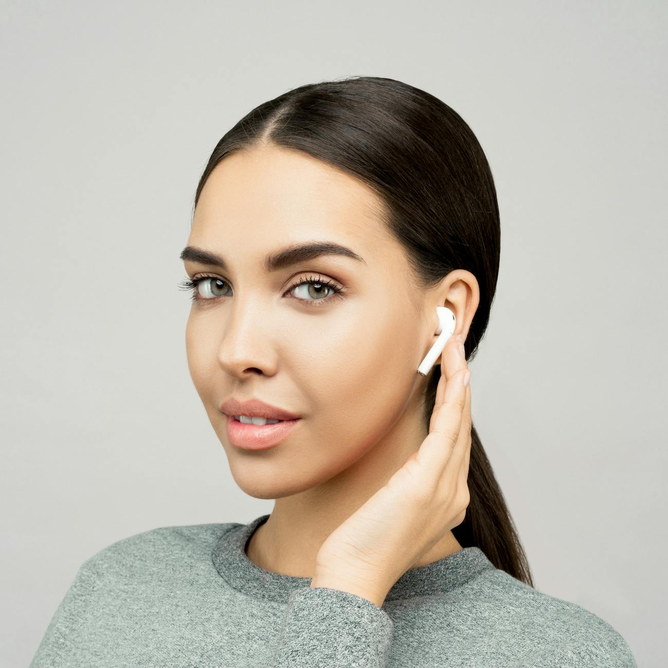close up photo of woman wearing grey sweater